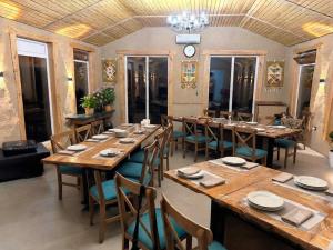 a large dining room with long tables and chairs at Kaganat village in Uchar
