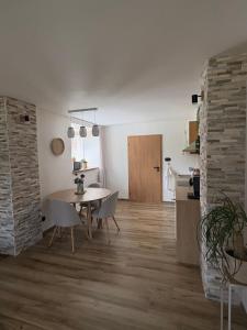a dining room and kitchen with a table and chairs at Azyl na statku 5 in Pardubice +12 photos