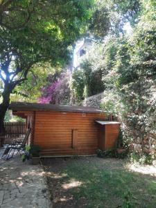 a small wooden cabin in a yard with trees at Chalet au centre de Nice in Nice +3 photos