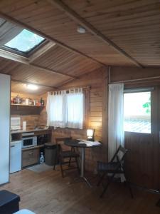 a kitchen with a table and chairs in a cabin at Chalet au centre de Nice in Nice