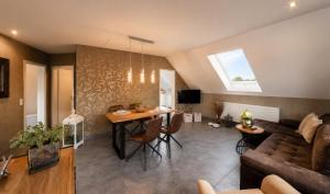 a living room with a couch and a table at Lifestyle in Kurort Steinbach-Hallenberg