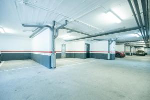 an empty parking garage with a car parked in it at Apartaments VM Molleres in Soldeu