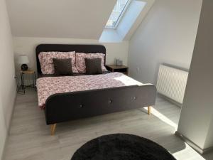 a bedroom with a large bed with a window at Apartment AFRODITA Trnava - Historic centre in Trnava