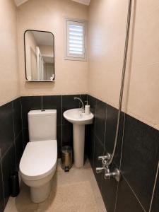 a bathroom with a toilet and a sink and a mirror at Kennedy Apart Hotel Kumkapı Istanbul in Istanbul +10 photos
