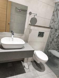 a bathroom with a sink and a toilet at The Sky Deck in Haldwāni