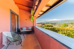 a balcony with a bench and a view at Elgio' Design Retreat with Etna View Taormina in Taormina +128 photos