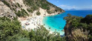 a beach with a bunch of people in the water at Vasiliki Bay in Vasiliki