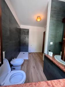 a bathroom with two toilets and a shower and a sink at A lì dai Nûtis in Venzone