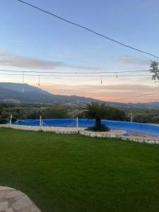 a view of a swimming pool from a yard at Κτήμα ΓΟΥΡΔΟΎΠΗ Georgιο in Lalióti