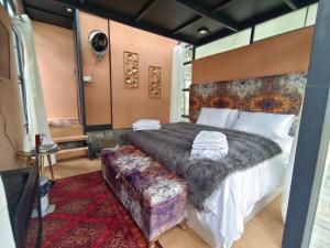 a bedroom with a large bed and a couch at Cloud Nine And A Half in Hunza Valley