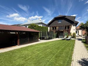 a house with a large lawn in front of it at Chalupa GABO pre 15 osôb in Habovka