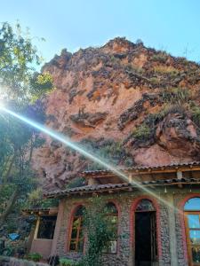 a house with a fire hydrant on top of a mountain at El molle in Pisac