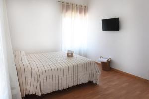 a bedroom with a bed with a striped blanket at Casa Nora in Valsinni