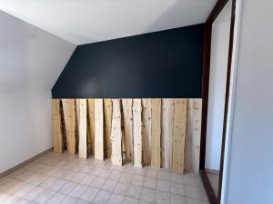 a room with a bunch of wooden walls at Hôtel le Tilleul in Corps