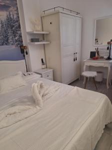 a bedroom with a large white bed and a desk at Merano appartamento in Merano +26 photos