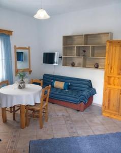 a living room with a couch and a table at Petroula Apartments II in Emborios
