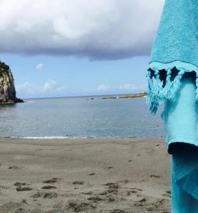 a towel on a beach with the ocean in the background at Casa Da Praia in Porto Formoso