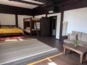 a bedroom with a bed and a bench and a table at Villa Fundemia in Gorna Breznitsa +37 photos
