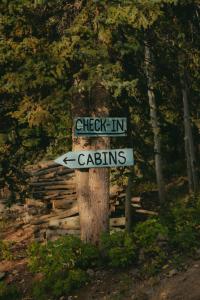 a sign that says check in and caliths at CabinsOver Crag Lake Glamping Bear in Carcross +2 photos
