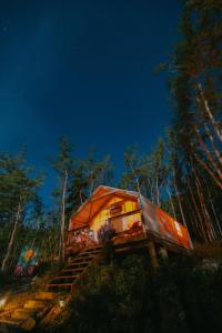 an orange tent sitting on a set of stairs at CabinsOver Crag Lake Glamping Bear in Carcross
