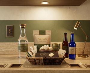 a counter with a bottle of wine and a basket of food at Hotel Mashabrum Skardu in Skardu