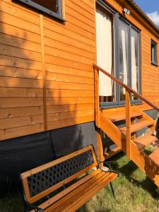 a wooden stairs leading up to a cabin with a window at Maringotka na kopečku in Kotaneč
