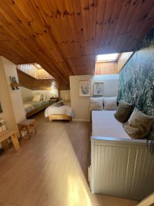 a bedroom with two beds and a wooden ceiling at Escapada in Puigcerdà