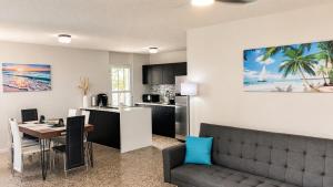 a kitchen and living room with a couch and a table at Casita Velera in Lajas