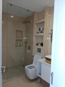 a bathroom with a shower and a toilet and a sink at Cabouqueiro's House in Mateuzinho