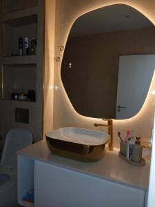 a bathroom with a sink and a mirror on a counter at Cabouqueiro's House in Mateuzinho