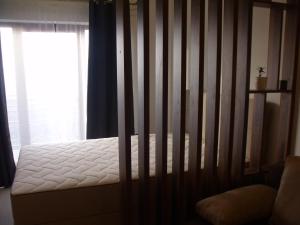 a bed in a room next to a window at Milmari N2 Erdeg in Kopaonik