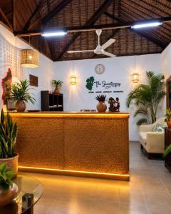 a hotel lobby with a reception desk and potted plants at The Sanctuary MADAGASCAR in Foulpointe +151 photos