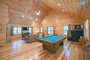 a pool table in a room with wooden walls at S'more Waggin' Cabin: Pet-Friendly--wifi, firepit, pool table in Blue Ridge