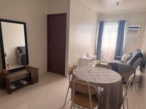 a living room with a table and a mirror at Linear Space at Soleia Butuan Unit G in Butuan