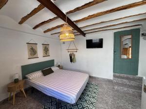 a bedroom with a bed and a chandelier at El Rincón de Laura - Quesada in Quesada