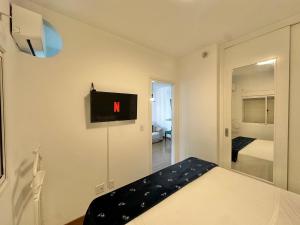 a bedroom with a bed with a clock on the wall at Flat Funchal JK Limpeza Diária, Internet 300mb in São Paulo +18 photos