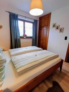 a large bed in a room with a window at Ferienwohnung Schösserhof in Reith bei Kitzbühel