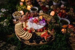 a plate of food on a table with fruit and vegetables at Hotel Boutique Finca La Niebla in Coatepec