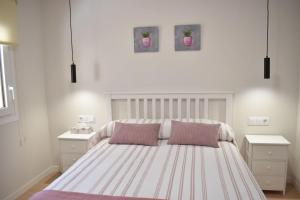 a bedroom with a large bed with two night stands at Casa El Abuelo in Bronchales