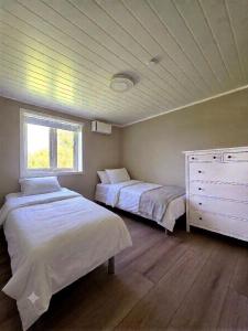 a bedroom with two beds and a window at Unique Villa by a beautiful lake in Omberg