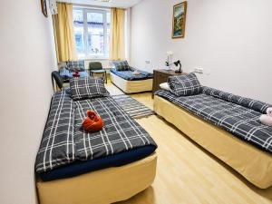 a room with two beds with a stuffed animal on it at Paide Event Center Hostel in Prääma