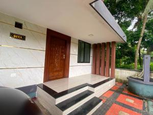 a building with a door and stairs in front of it at Siya's home in Udupi