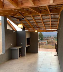 a patio with a wooden roof with a view at Complejo Aiken in Trevelín