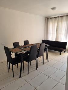 a dining room with a table and chairs and a couch at Taltal - Cabañas in Taltal