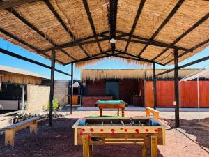 a ping pong table under a wooden pavilion at Taltal - Cabañas in Taltal