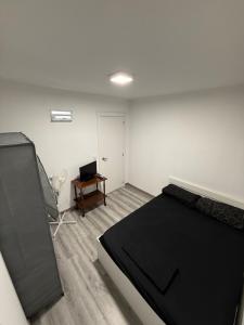 a bedroom with a bed and a table and a chair at Alojamiento confort in Vigo