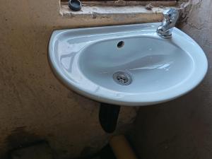 a white sink in a bathroom with austed at Potch Guest Home in Potchefstroom +10 photos