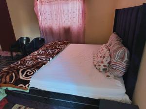 a small bed in a room with a window at Potch Guest Home in Potchefstroom