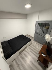 a small room with a bed and a table at Alojamiento confort in Vigo