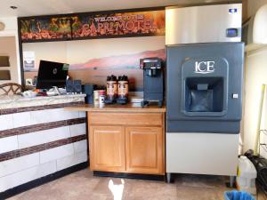 a kitchen with a stove and a ice machine at Capri Motel in Walla Walla